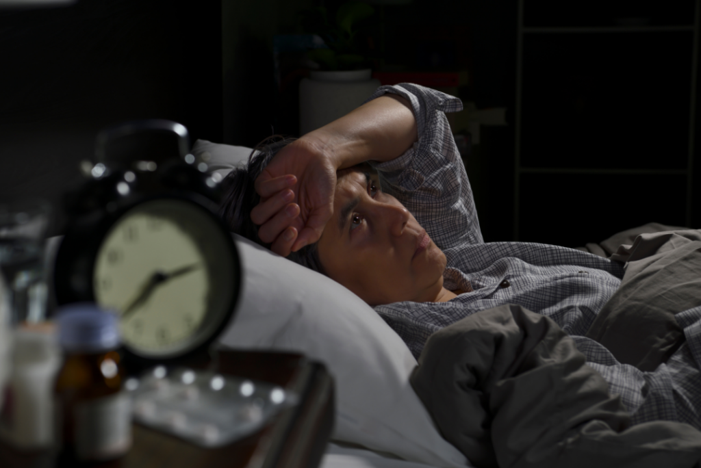 Woman With Insomnia Awake in Front of Alarm clock