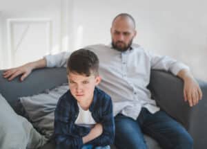 angry child on couch with father