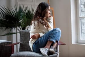 Teenager siting in a chair turned away angrily