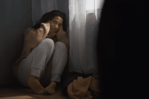 Woman on Floor Clutching Head