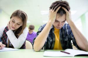 Young man struggling with schoolwork