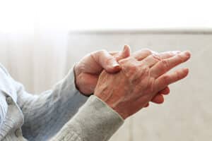 Older person holding shaking hands