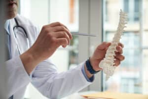 Doctor pointing to spine model