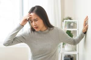 Young woman holding head in pain