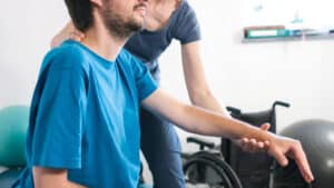 Man with muscular dystrophy at therapy