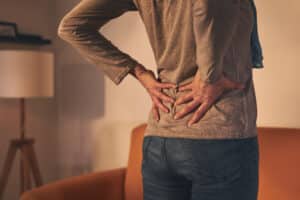 Woman holding lower back in pain