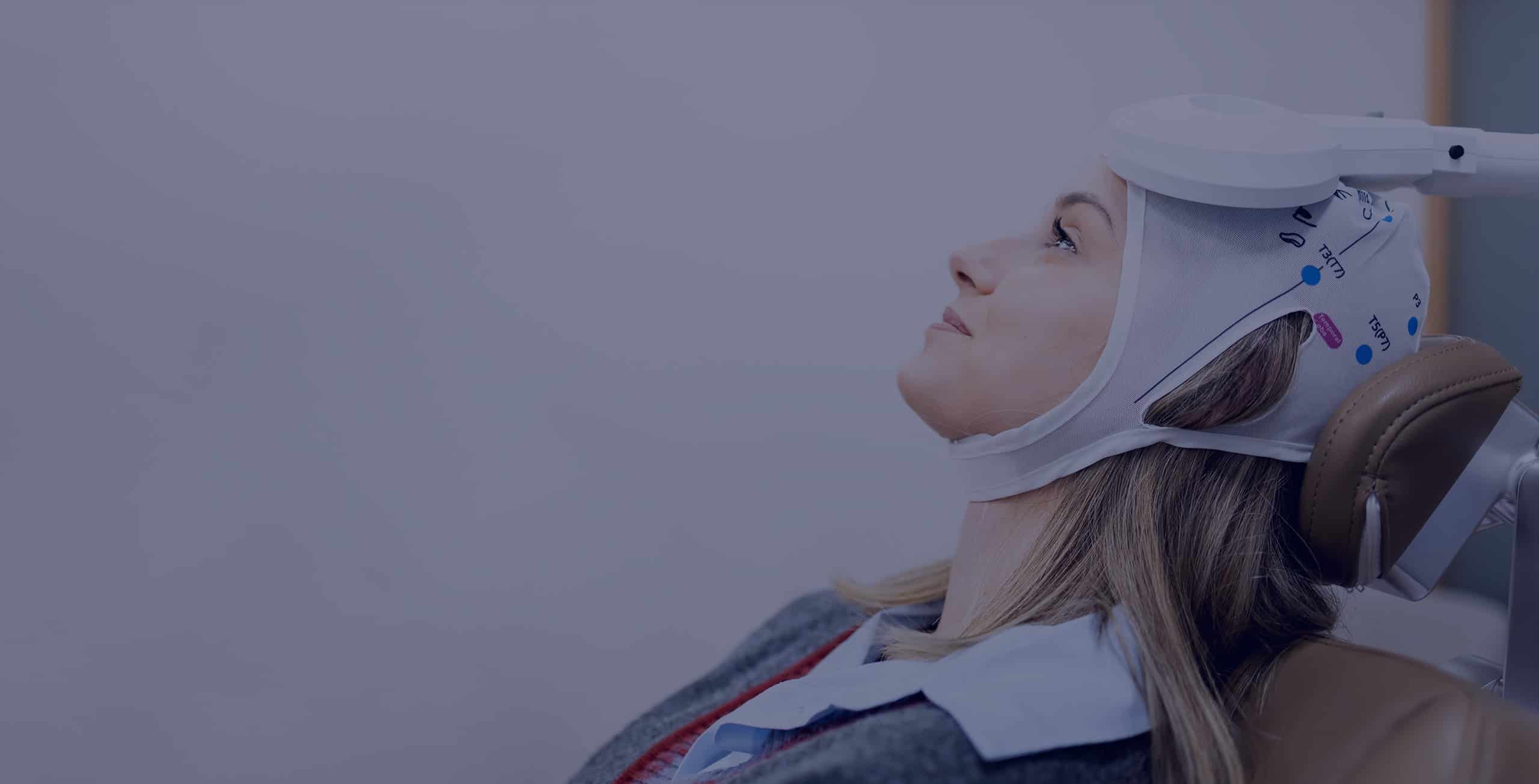 A woman undergoes transcranial magnetic stimulation therapy at a psychiatric center.